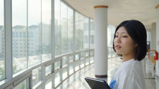 Woman looking out the window indoors