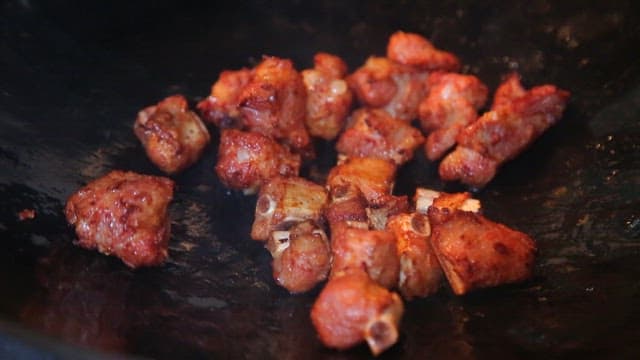 Sizzling meat and vegetables in a pan