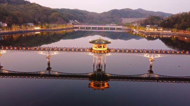 Scenic bridge over a calm river at night