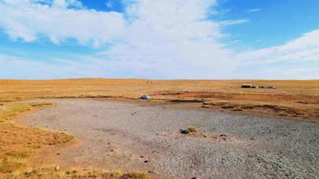 Expansive Field with Scattered Vehicles