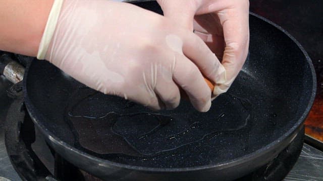 Cracking an egg into a frying pan