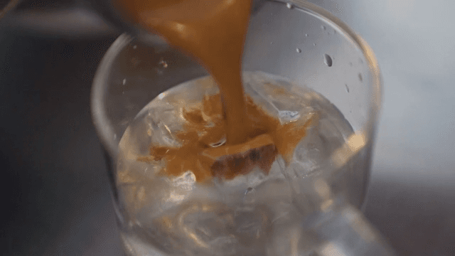 Pouring Espresso into Cup with Ice