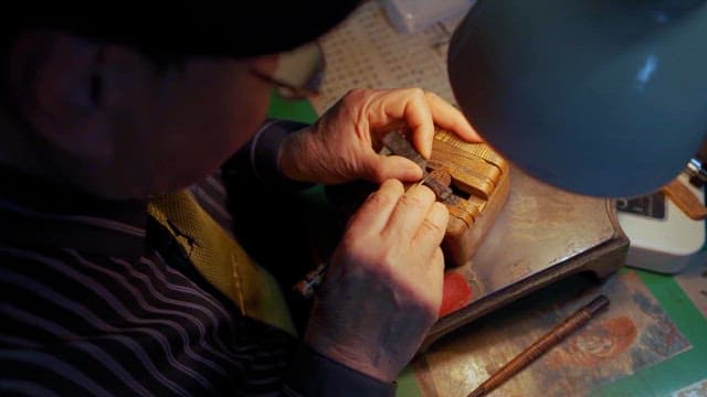 Craftsman Carving Wood in Workshop
