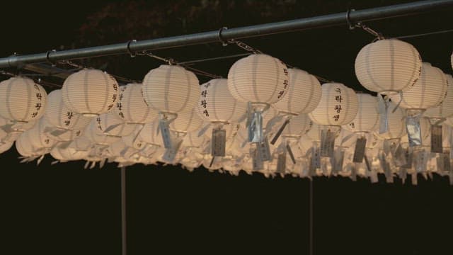 Scenery lit with lanterns praying for a return to paradise