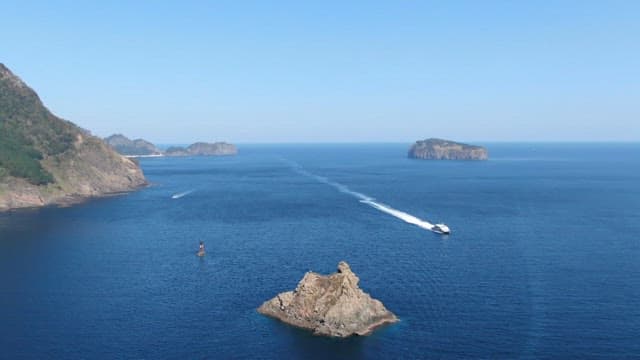 Coastal Scenery with Speedboat Navigating