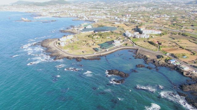 Coastal landscape with ocean and buildings