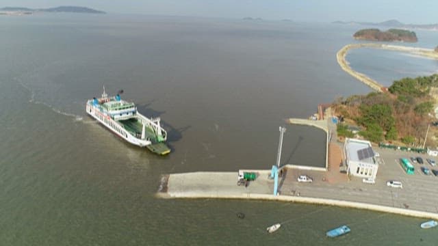 Aerial view of ferry arriving at coastal port