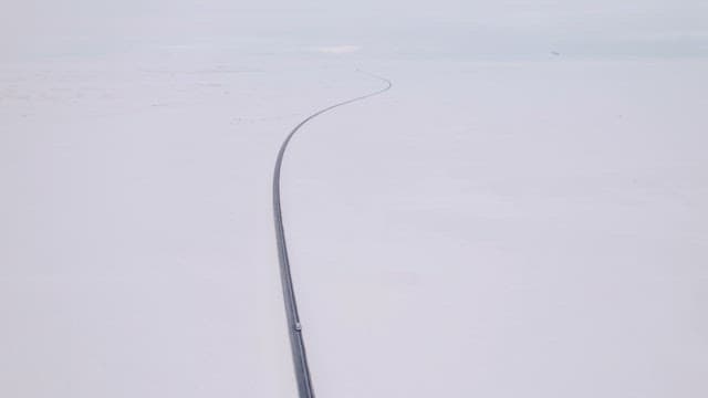 Long road stretching through snowy plains