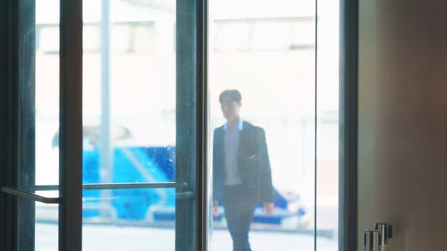 Man in a suit entering a building