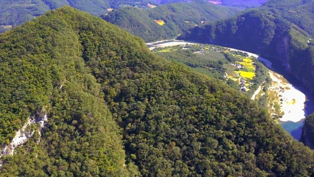 Rural village next to a river and majestic mountain ranges