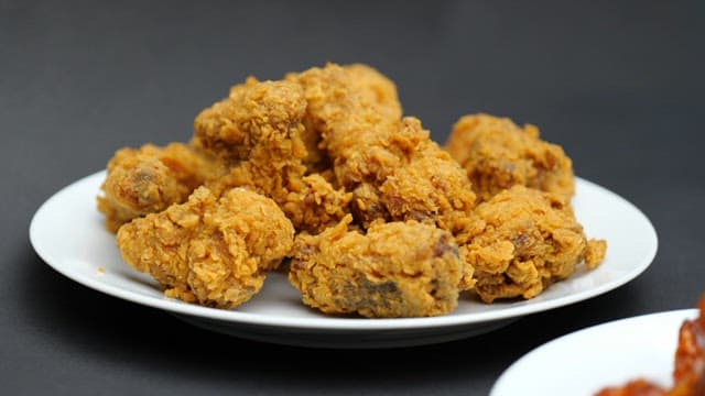 Fried chicken and seasoned chicken on a white plate