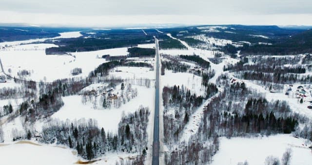 Snowy landscape with a long road