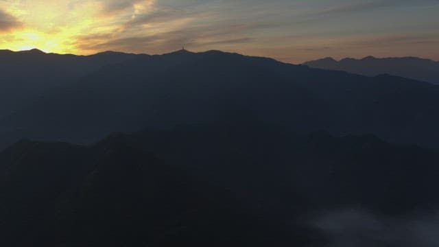 Lush Mountains Surrounded by Thick Fog