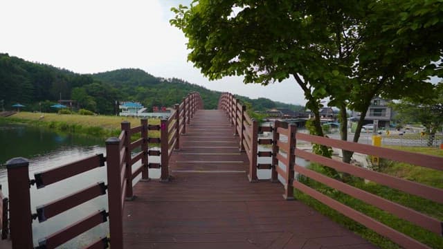 Footbridge Over the Lake Leading to Scenic Village
