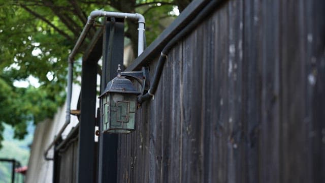Street Lamp Hanging on a Wooden Fence
