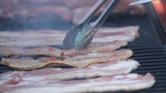 Grilling pork belly on a barbecue grill