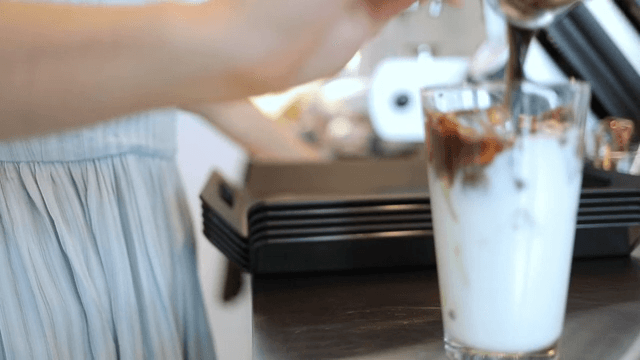 Adding espresso to milk to make a cafe latte