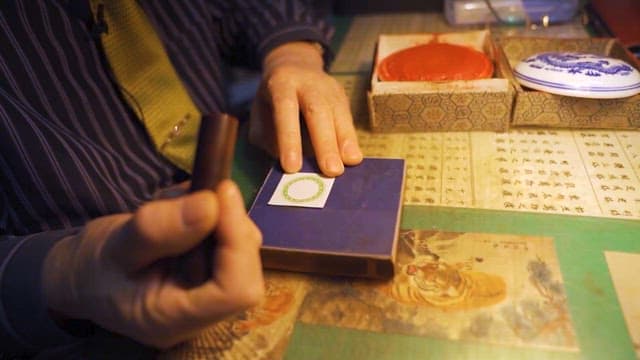 Craftsman Applying Seal on Paper