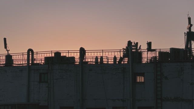 Sunset over city skyline with rooftops