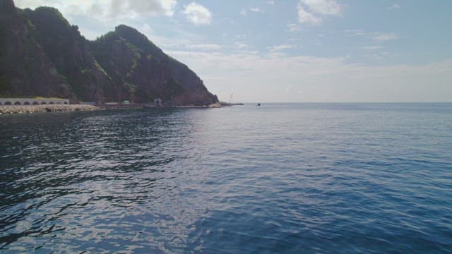Coastal cliffs and calm sea under a clear sky