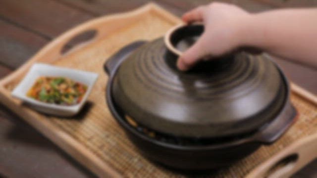 Korean mussel rice in a clay pot and seasoning sauce