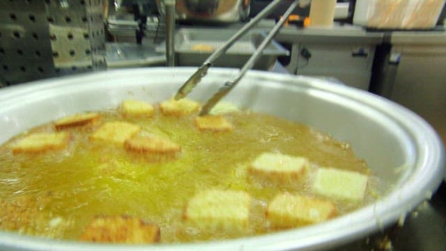 Bread slices frying in hot oil