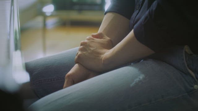 Person seated indoors playing the piano