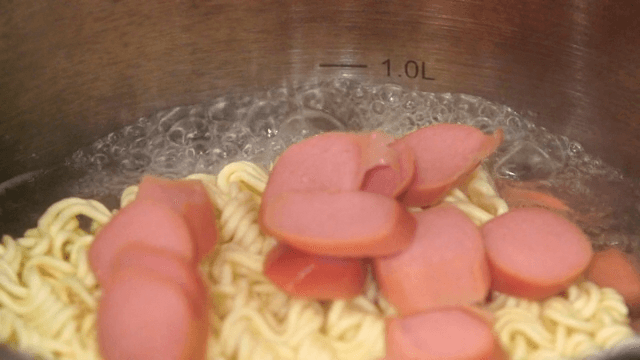 Ramyeon with sausage being prepared