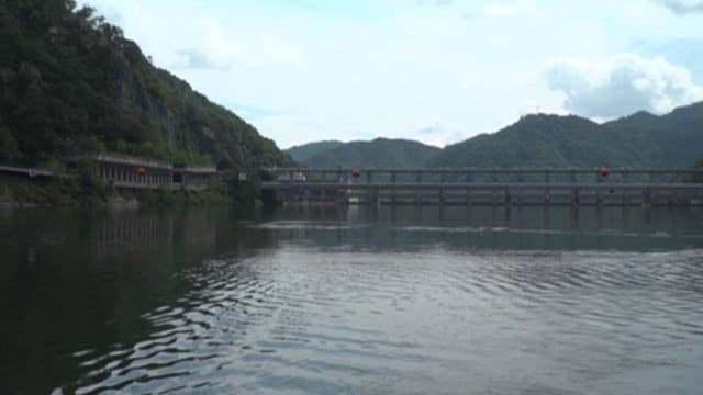Serene Lakeside View with Road and Bridge