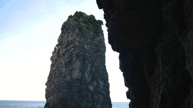 Majestic Sea Cliff Towers Above Calm Waters
