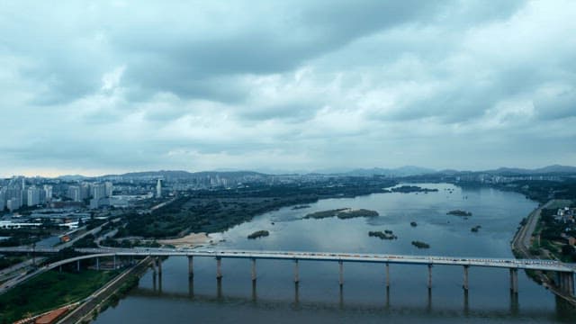 A city skyline with a river and bridge