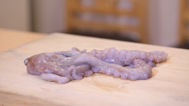 Chopping Octopus on a Wooden Cutting Board