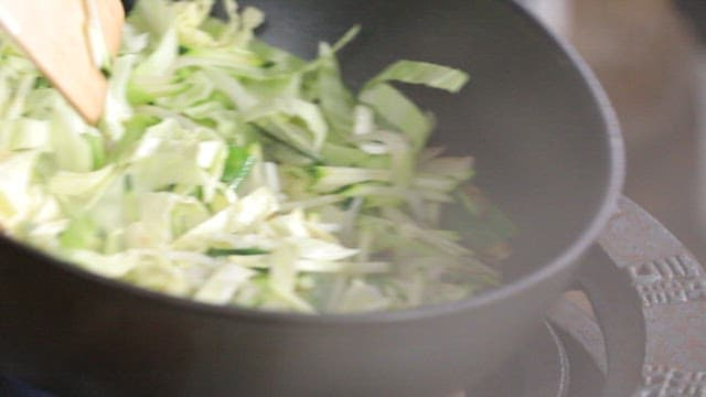 Vegetables being stir-fried in a pan