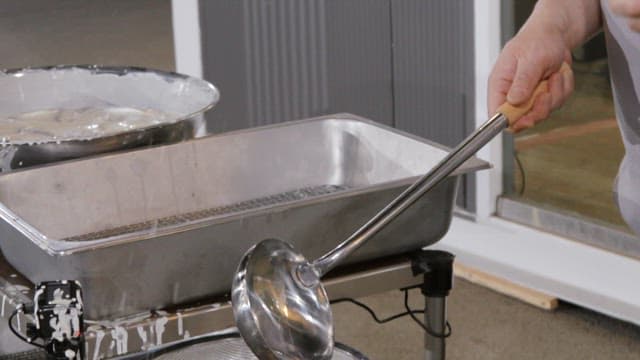Fried fish with seasoning and vegetables stir-fried in a frying pan