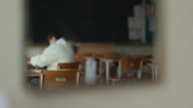 Student Studying Alone in Classroom
