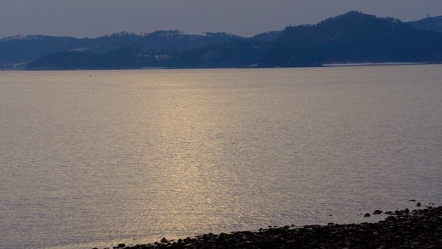 Calm sea and beach with evening sunset