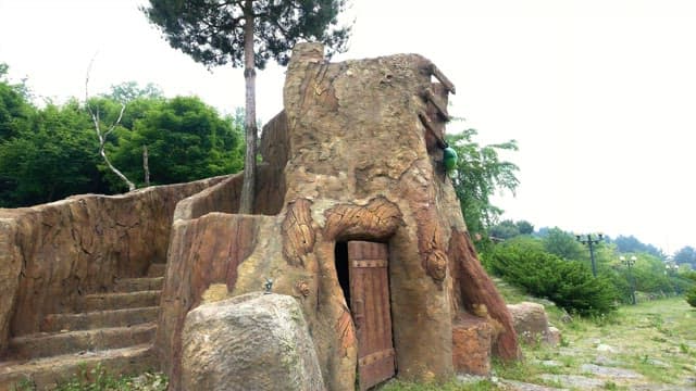 Sculpture with a gate in a lush green park
