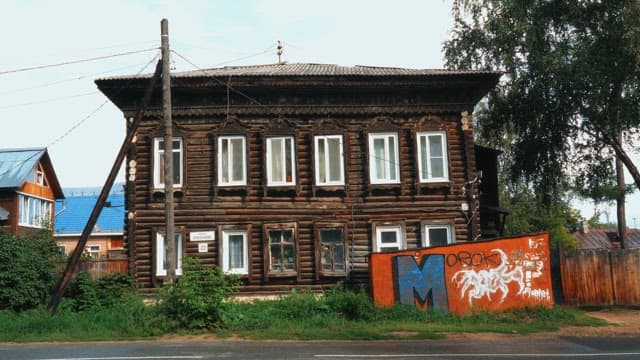 Old wooden house with graffiti on a sunny day