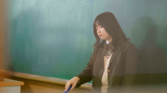 Student cleaning a classroom