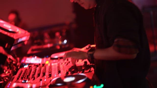 DJ Performing Under Dazzling Lights