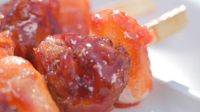 Fried fish and rice cake skewers with spicy sauce