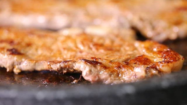 Juicy beef sizzling on a hot grill