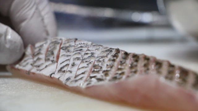 Fish cooked with a torch after being carefully sliced