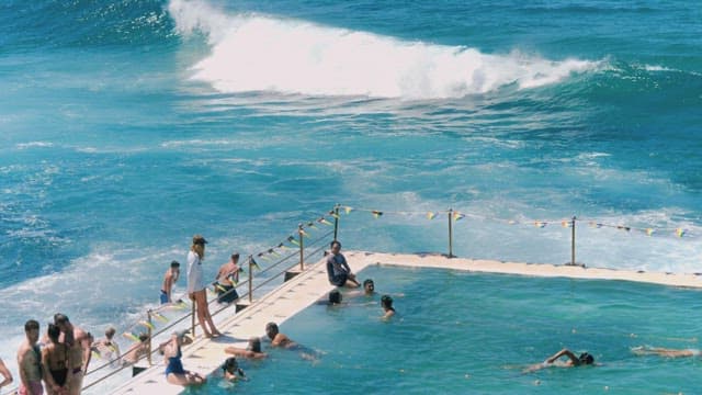 People Enjoying Water Fun in a Beach Pool on a Sunny Day
