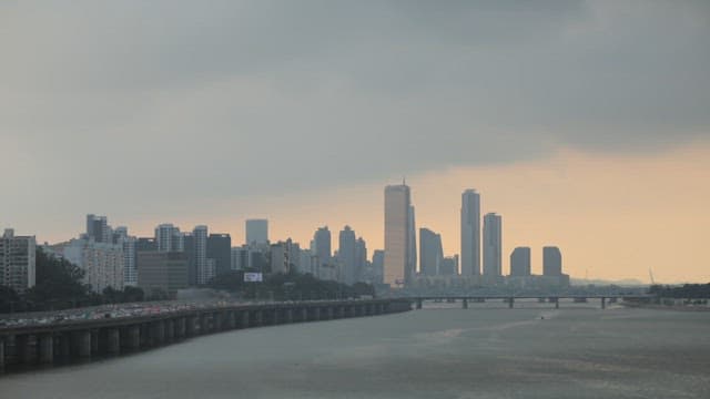 Day and Night Scenery of a City Along the River