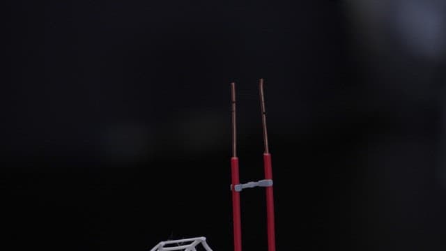 Scientist applying glue to an electrode wire while wearing gloves