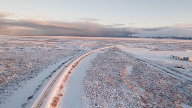 Snowy landscape with a long road