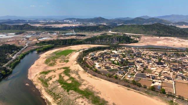 Traditional village surrounded by a river