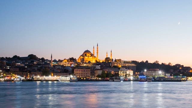 Boats passing through the Bosphorus with a view of the mosque