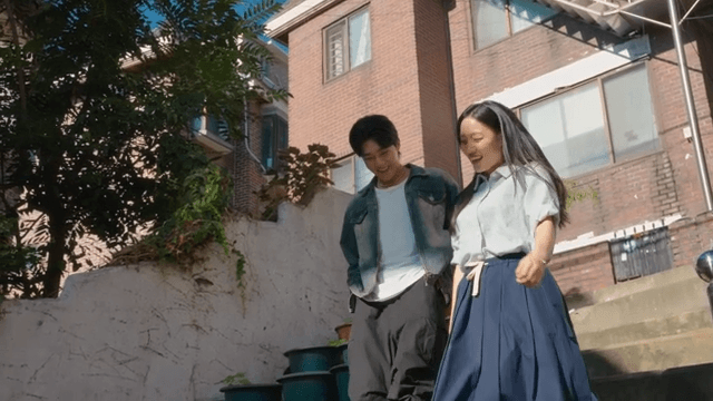Couple walking down sunny stairs